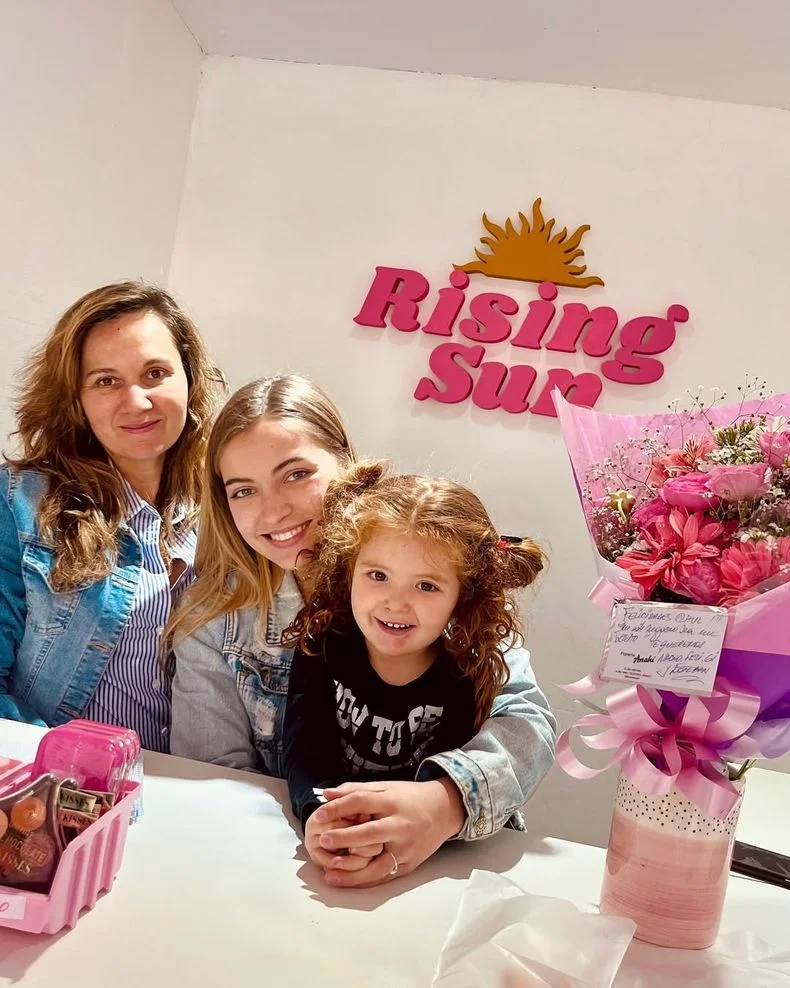 Junto a su madre y su hermanita, en su local de moda.